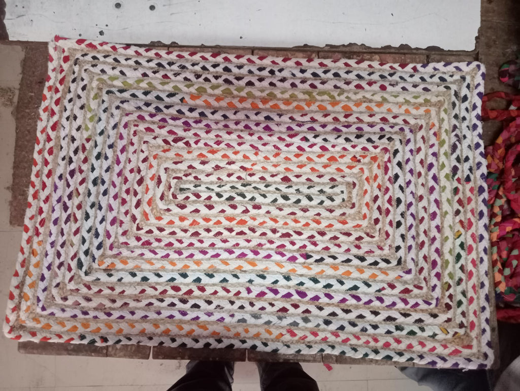 Original photo of rectangular cream and multicolour braided mat