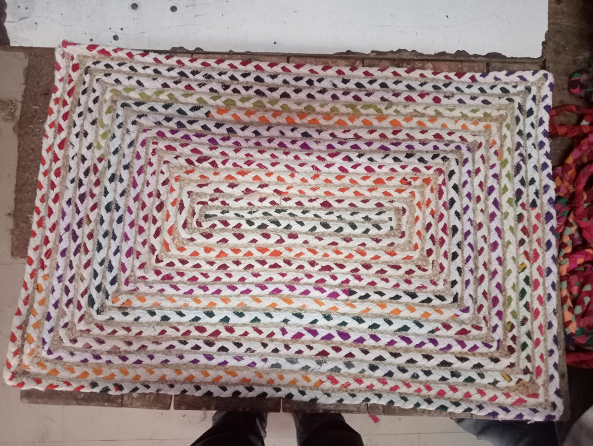 Original photo of rectangular cream and multicolour braided mat