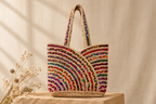 Full colorful braided tote styled on a sandstone plinth against a neutral linen backdrop